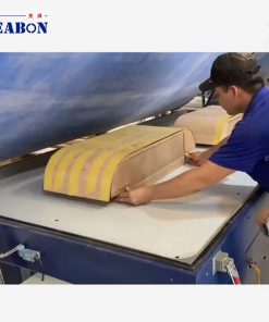 Operator loading a curved door panel into the PV-2500A vacuum membrane press