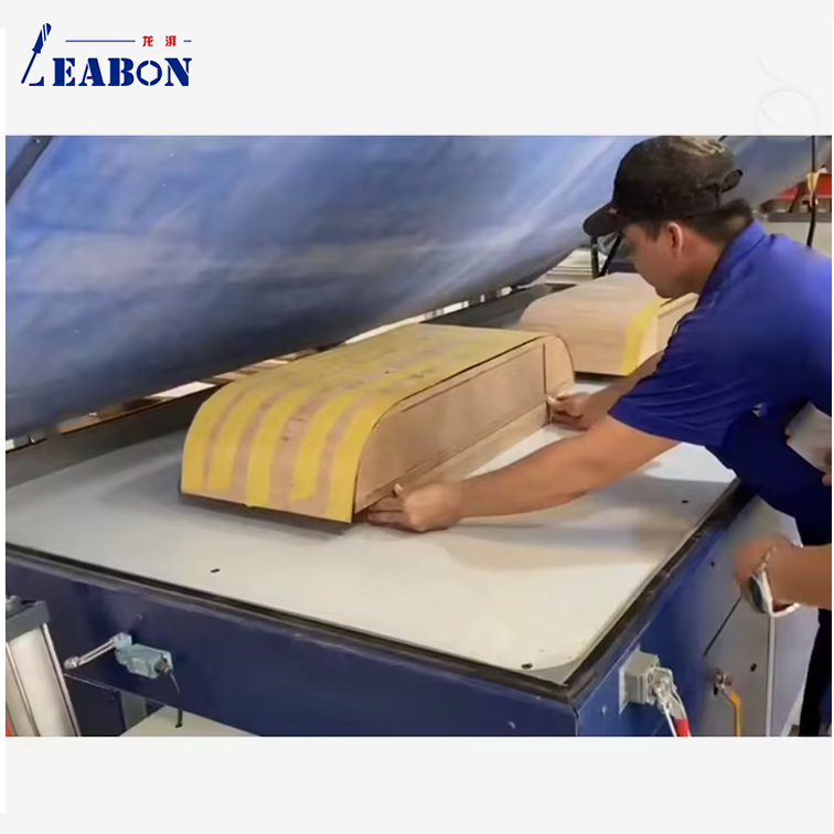 Operator loading a curved door panel into the PV-2500A vacuum membrane press